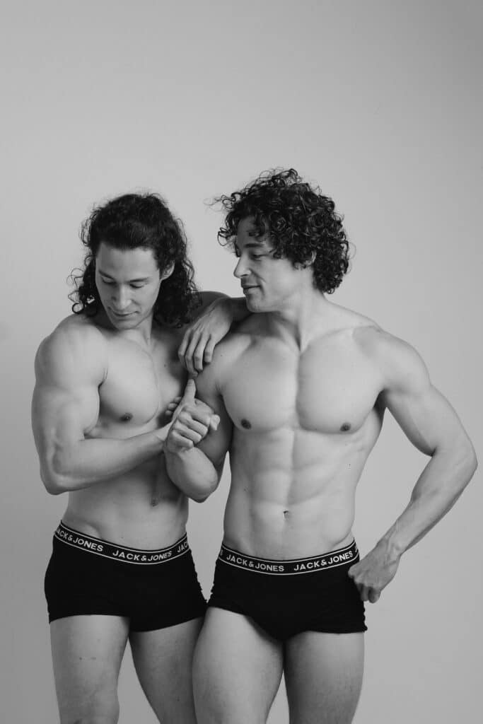 Zwei athletische Männer im Studio in Unterwäsche – Schwarzweiß Fitnessportrait